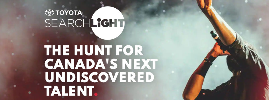 CBC Searchlight stage with performer singing and text that reads Toyota Searchlight. The hunt for canada's next undiscovered talent.